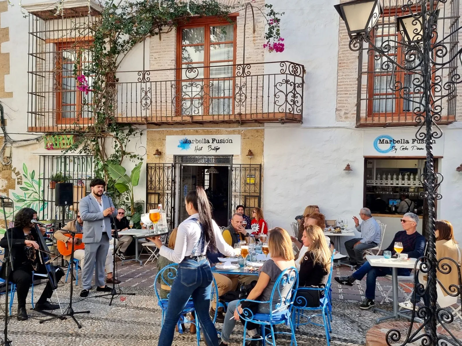 Terraza de un restaurante del casco antiguo de Marbella con clientes y músicos tocando